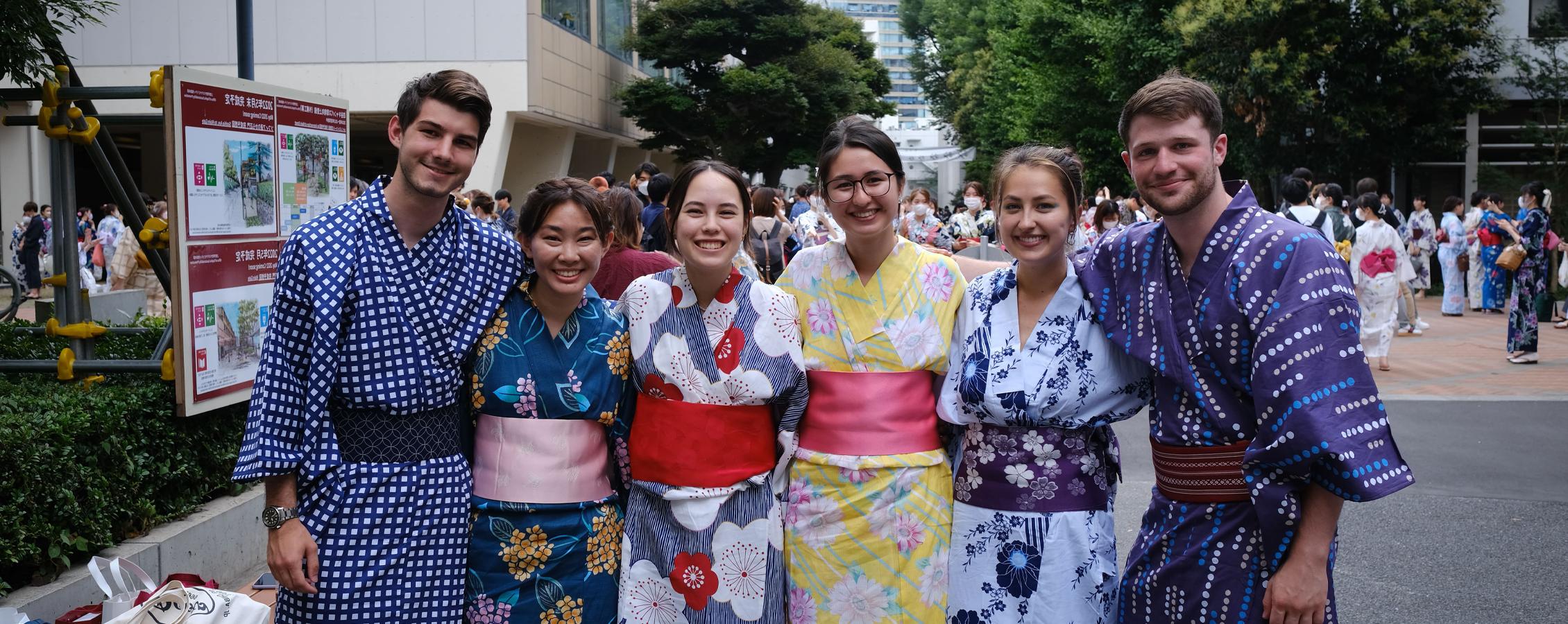 Students pose together while wearing obis in Japan.
