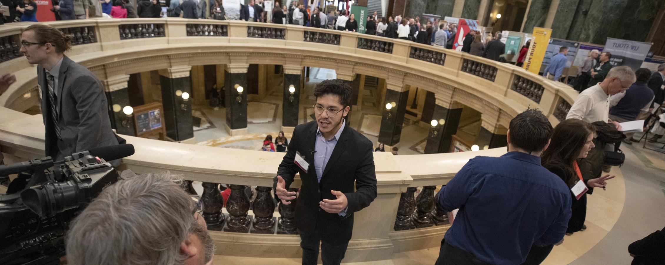A student does an interview at the Capitol building.